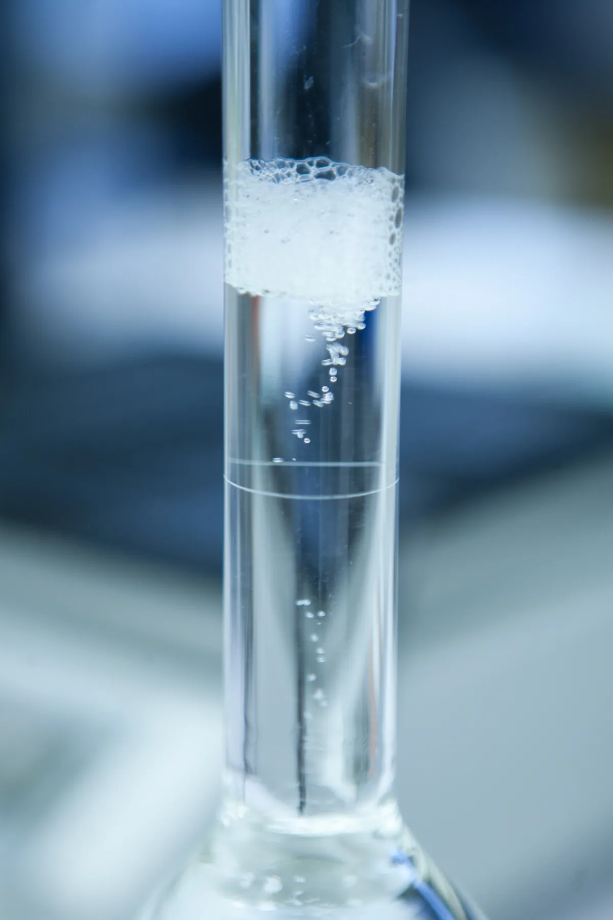 Glass flask with bubbling liquid in gene therapy experiment